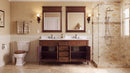 Antique brown Rocaille Victorian double vanity in a bathroom with glass shower, doors open showing the shelves